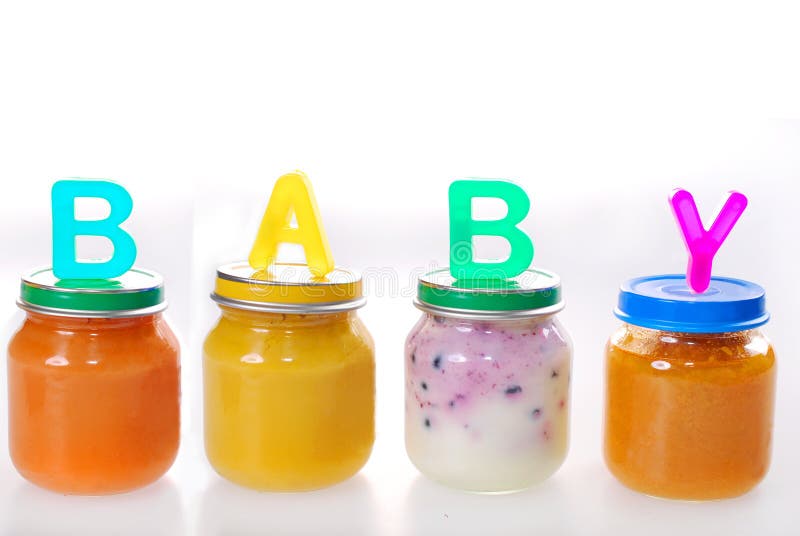 Baby food in jars. Assortment of baby food in jars with letters making word baby on the top isolated on white royalty free stock images