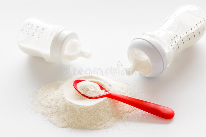 Baby Food. Powder in Spoon Near Baby Bottle on White Background Stock