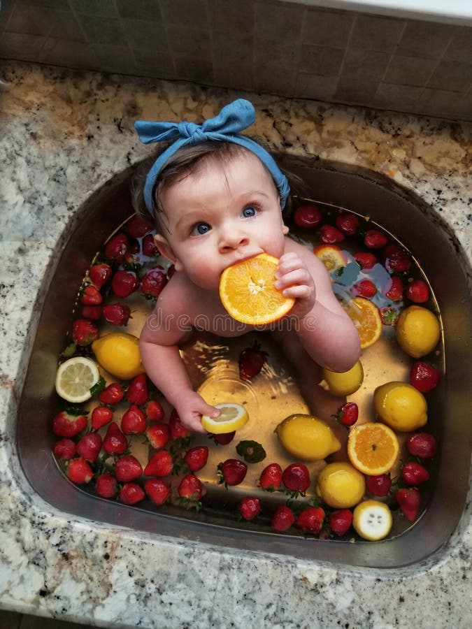 Baby in a Fruit Bath in Kitchen Sink Stock Image Image of