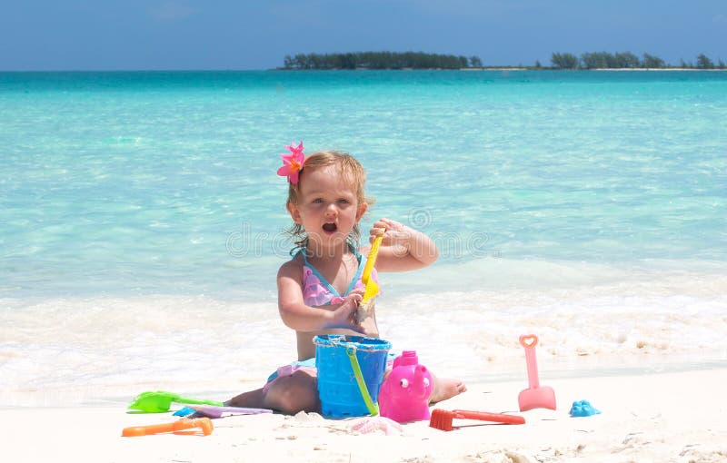 A baby girl on the beach stock photo