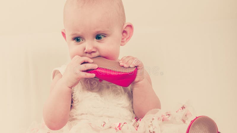 Baby girl biting shoe royalty free stock photo Baby girl biting shoe royalty free stock photo