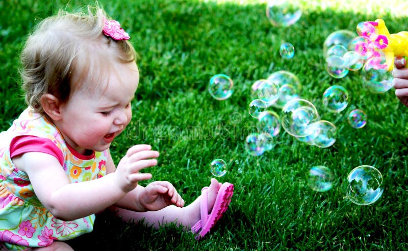 Baby girl crying with bubbles