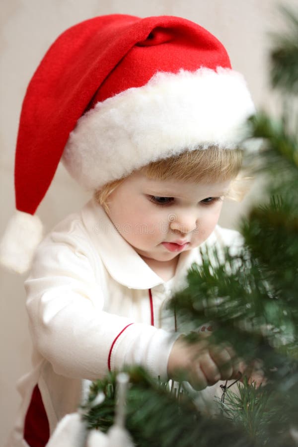 Baby girl decorate the Christmas tree