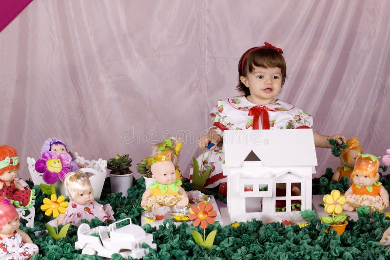 Baby girl and doll house