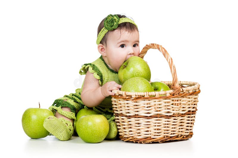 Baby girl eating green apples from basket royalty free stock photography Baby girl eating green apples from basket royalty free stock photography