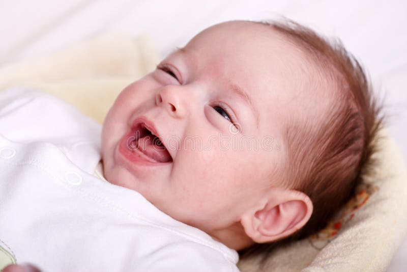 Baby girl laughing with toothless smile