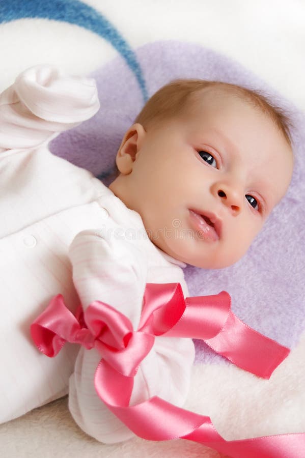 Baby girl with pink ribbon