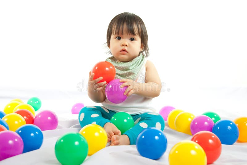 Baby girl is playing ball stock image. Image of interest 32991887