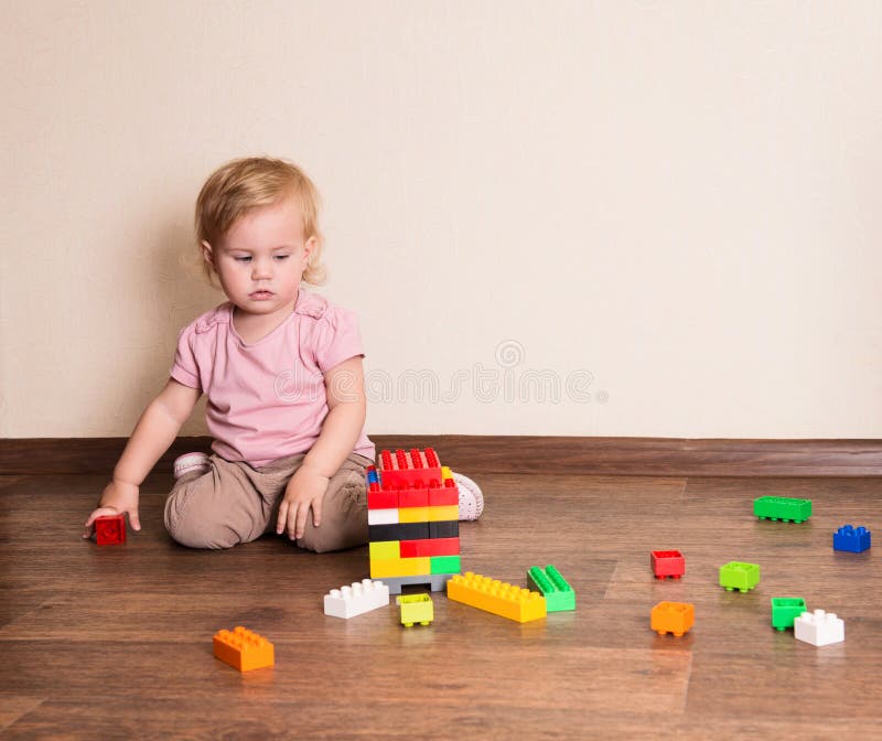 Baby girl playing with block toys at home or nursery royalty free stock image Baby girl playing with block toys at home or nursery royalty free stock image