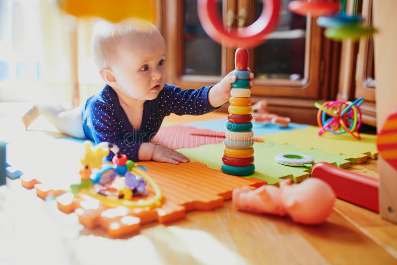 Baby Girl Playing with Toys on the Floor Stock Photo - Image of ...