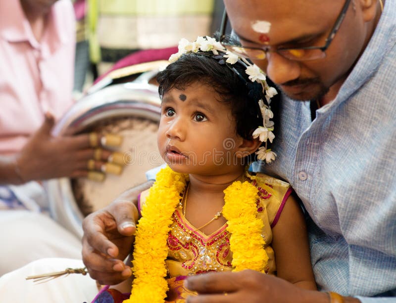 Baby girl received prayers from the karnvedh events. stock photo Baby girl received prayers from the karnvedh events. stock photo