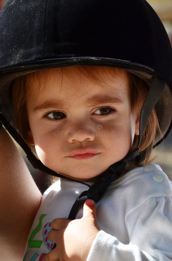 Baby girl rides pony horse