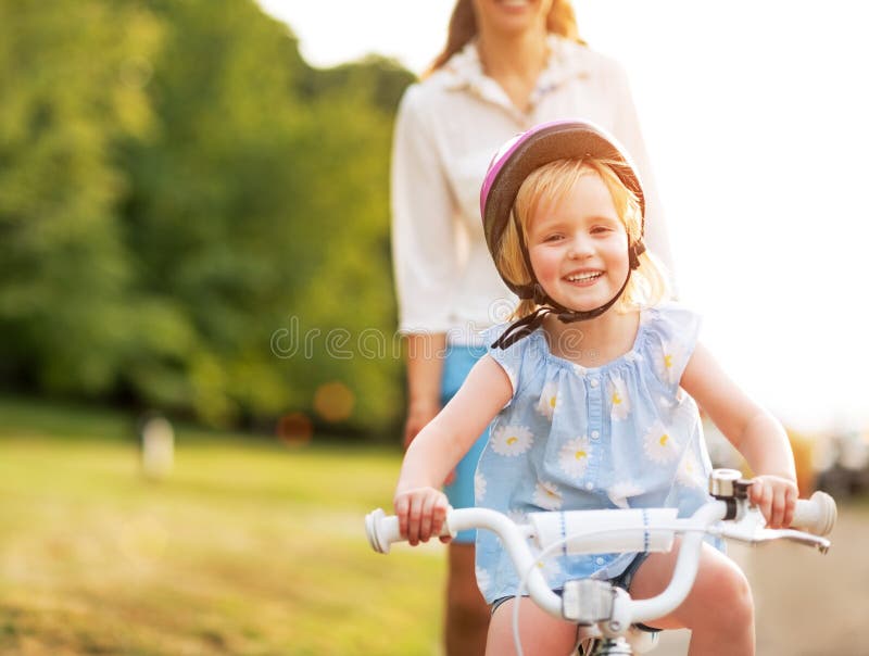 Baby girl riding bicycle stock image. Image of bike, female 44627359