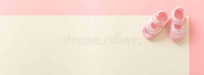 Baby girl shoes on pastel colors background, banner