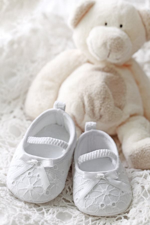 Baby girl shoes and teddy bear