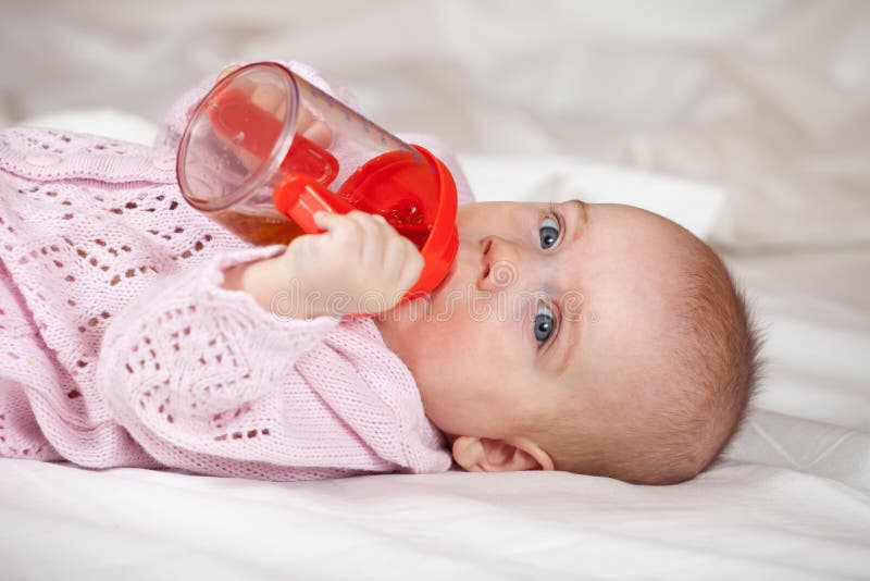 Baby girl with sippy cup