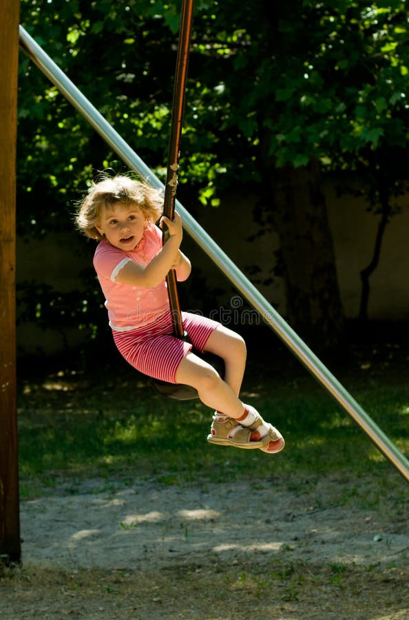 Baby girl on the Swing stock image. Image of swing, playing 21565621