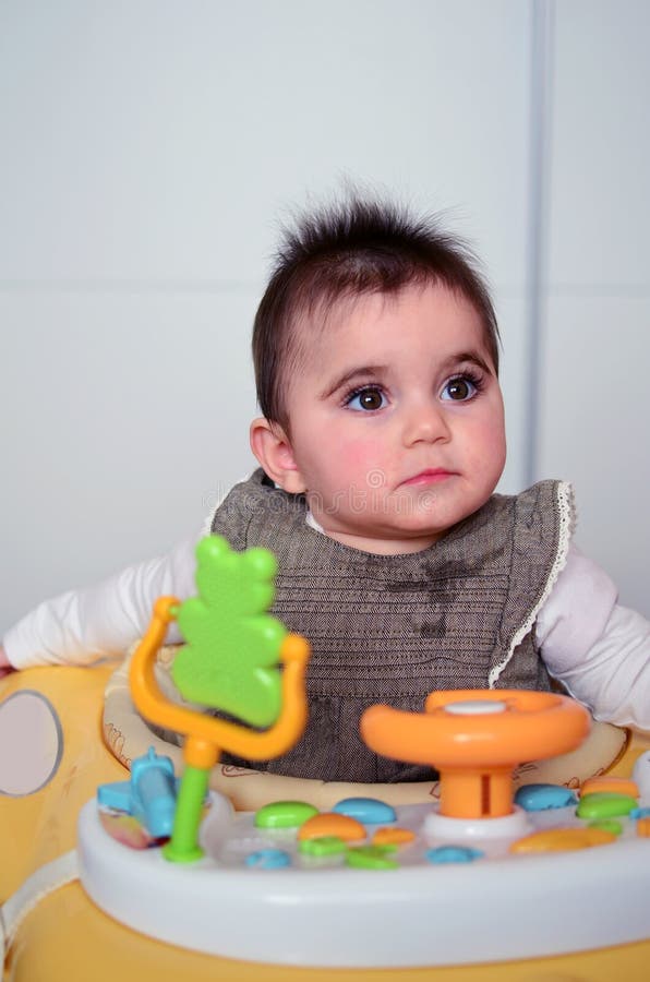Baby girl in a walker. stock photo. Image of funny, cheerful 51457630