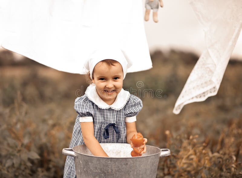 Premium Photo  Baby girl washing clothes by hand in a tin basin. retro  style. hand washing.