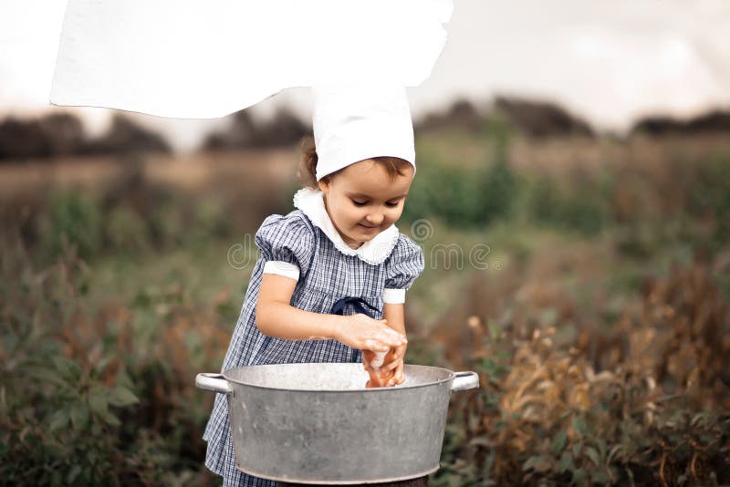 Premium Photo  Baby girl washing clothes by hand in a tin basin. retro  style. hand washing.