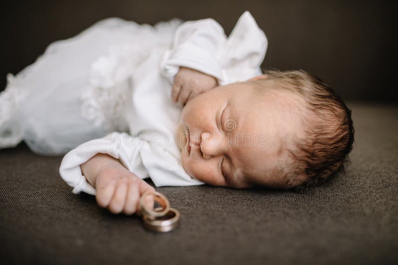 Baby Hand Holding Gold Wedding Ring. Baby Hand Holding Gold Wedding Ring