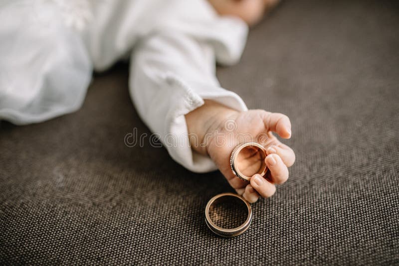 Baby hands and gold wedding rings. Baby hands and gold wedding rings