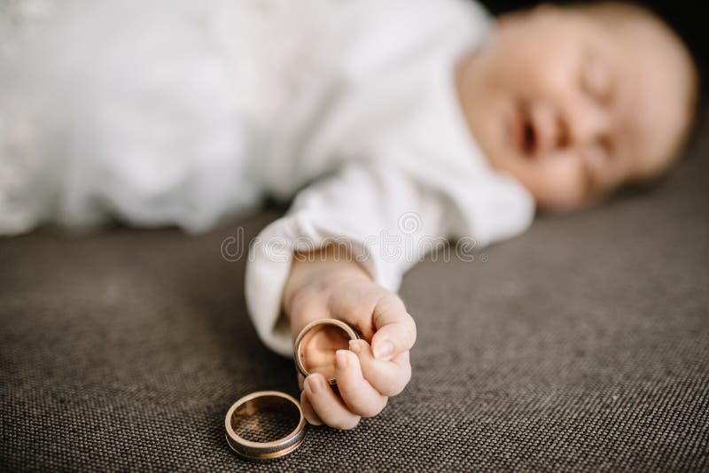 Baby hands and gold wedding rings. Baby hands and gold wedding rings