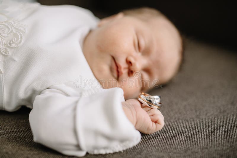 Baby hands and gold wedding rings. Baby hands and gold wedding rings