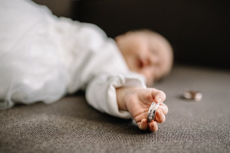 Baby hands and gold wedding rings. Baby hands and gold wedding rings