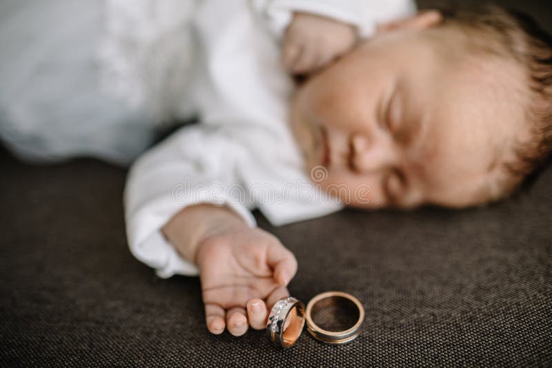Baby hands and gold wedding rings. Baby hands and gold wedding rings