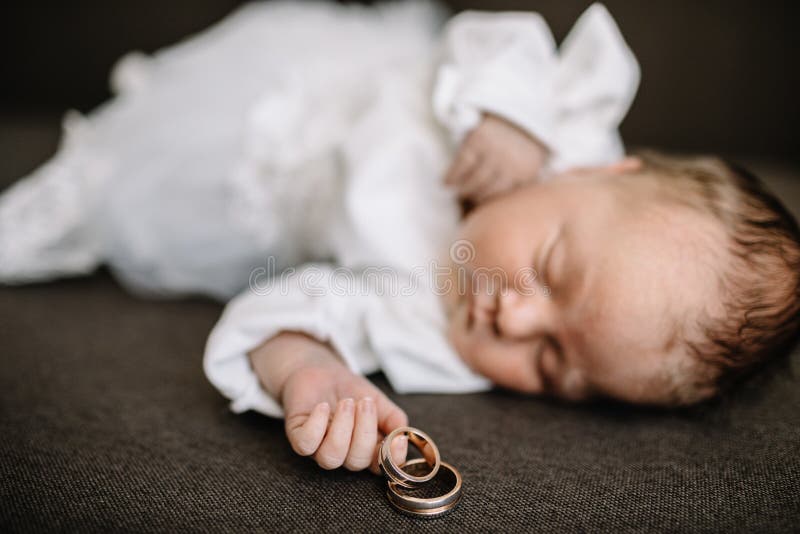 Baby hands and gold wedding rings. Baby hands and gold wedding rings