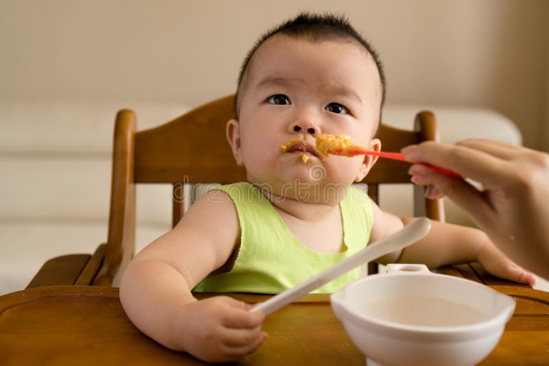 Baby having meal stock image. Image of infant, spoon - 97928803