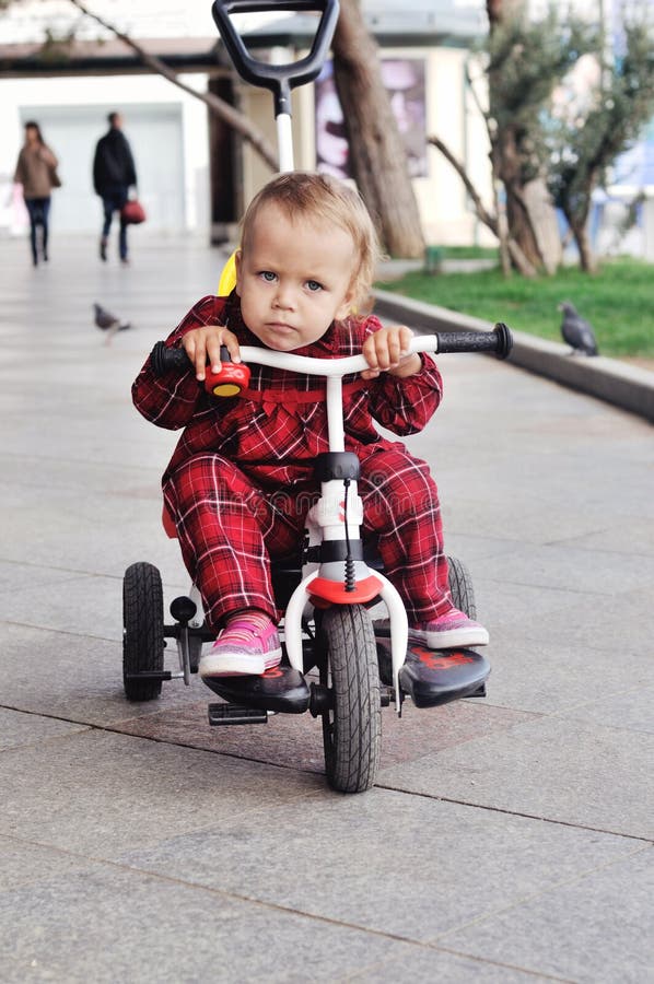 Baby on her tricycle stock image. Image of bicycle, achievement 30893659