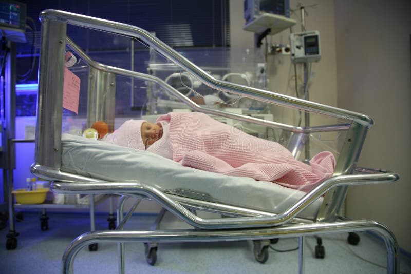 Baby in an incubator sleeping stock photos