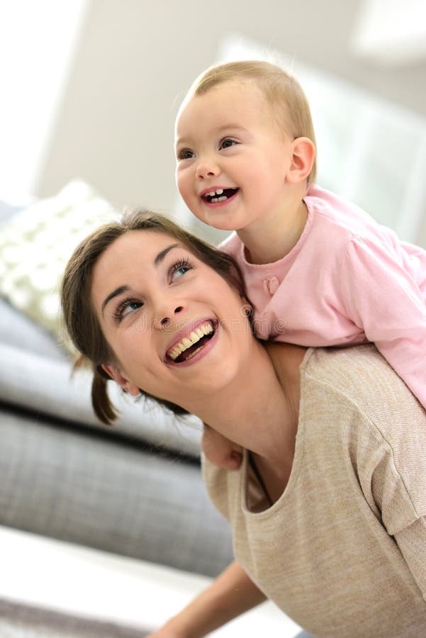 Baby laughing on her mother's back royalty free stock photos Baby laughing on her mother's back royalty free stock photos