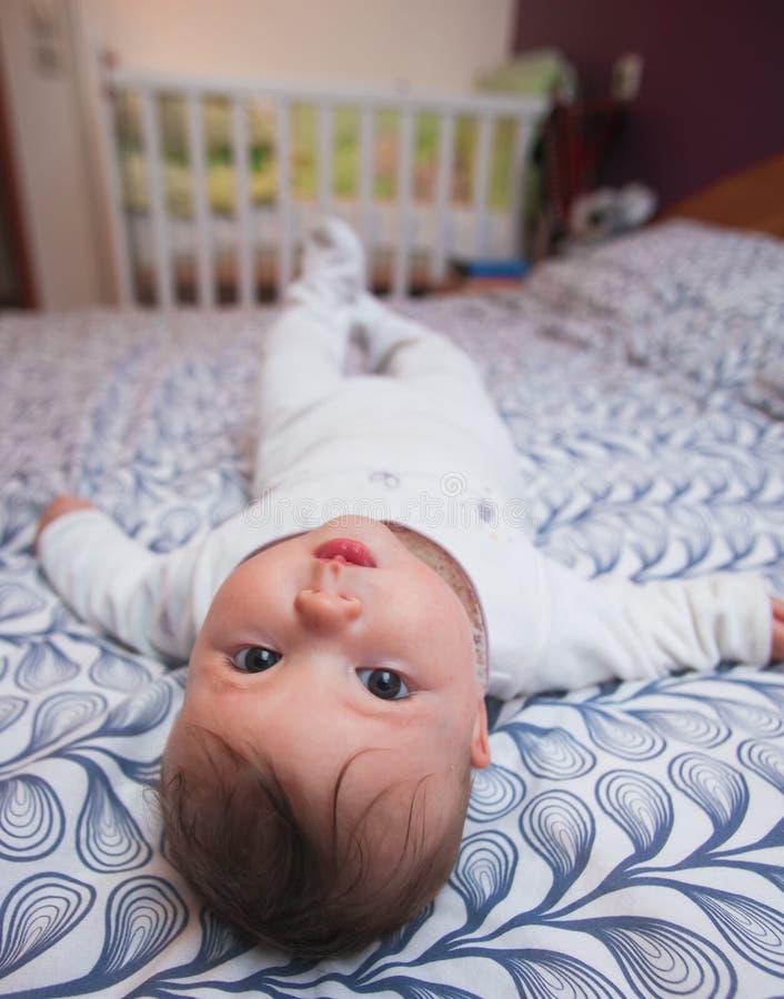 Baby laying on bed stock image. Image of bedtime, little 13520591