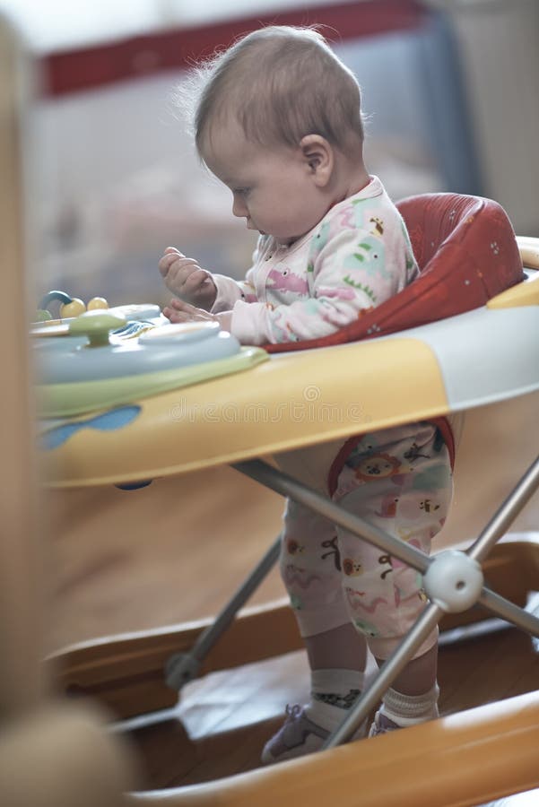 Baby Learning To Walk in Walker Stock Photo Image of child, innocence