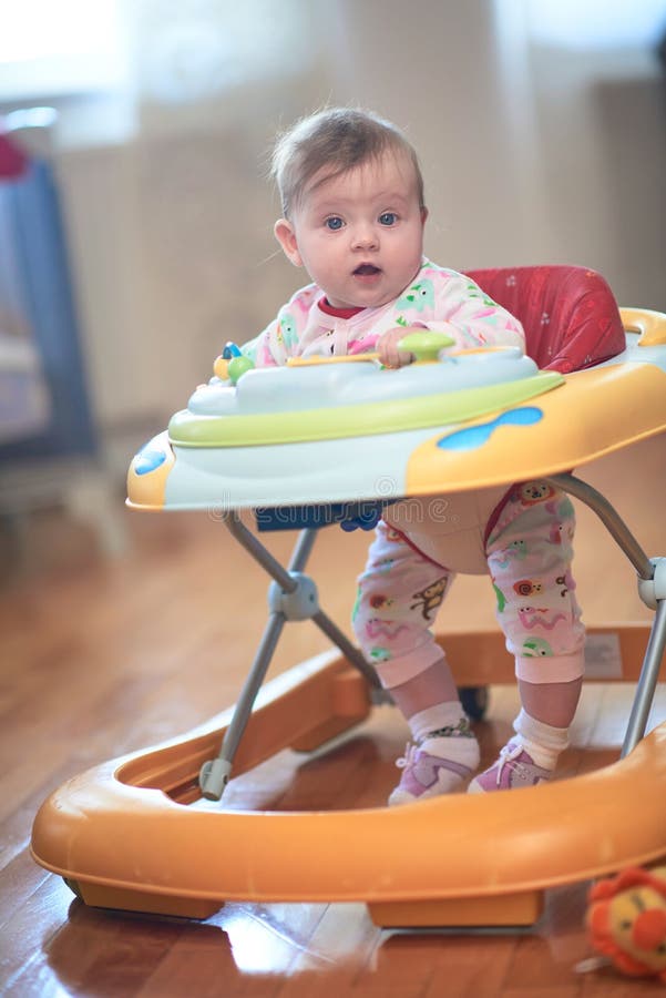 Baby Learning To Walk in Walker Stock Photo Image of girl, house