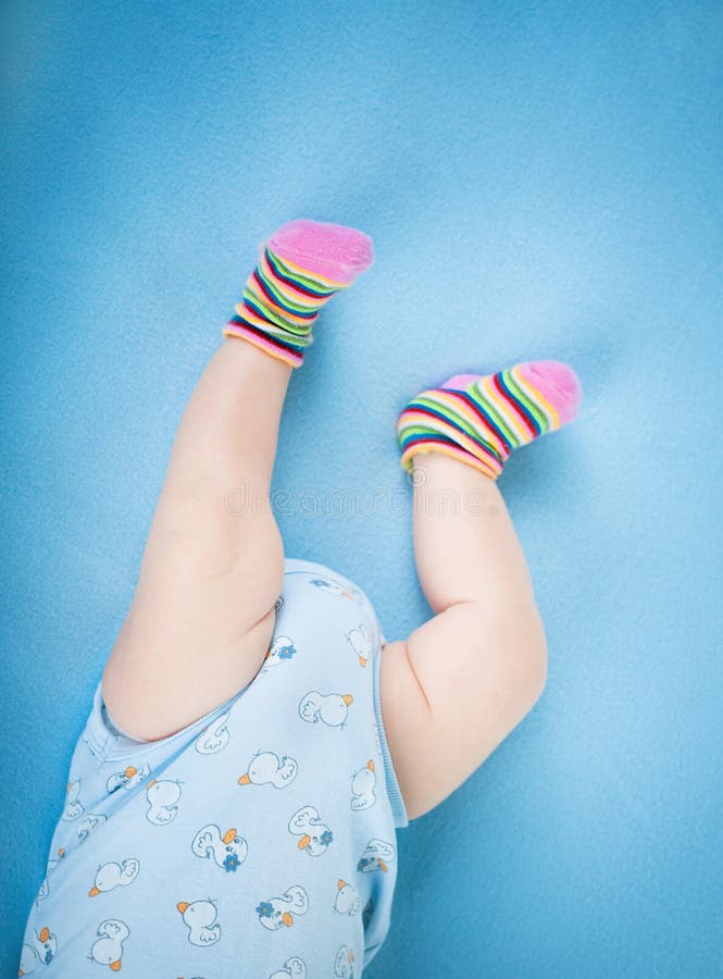 Baby legs on blue background