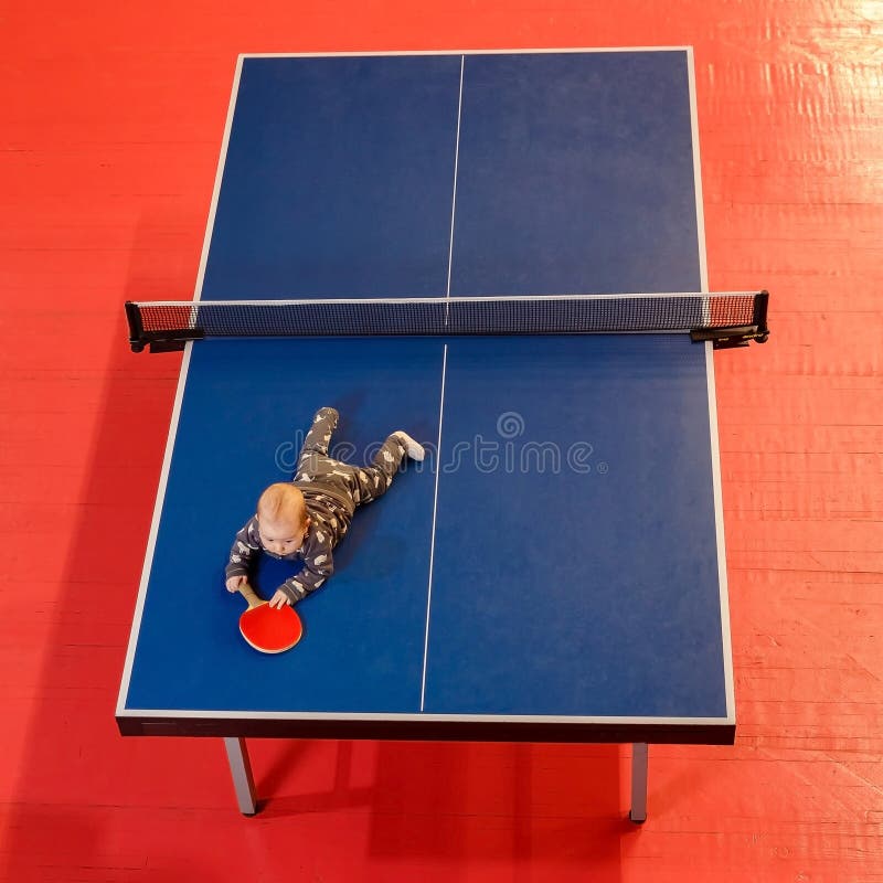 Baby lies on table tennis table