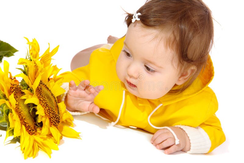 Baby looking at sunflowers