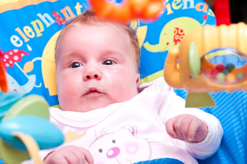 Baby looking at toys stock image. Image of infant, suspended 14395467