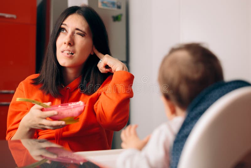 Baby Not Eating and Mother Ignoring Her Protesting stock image Baby Not Eating and Mother Ignoring Her Protesting stock image