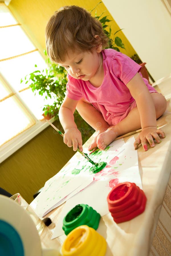 Baby painting with paint brush