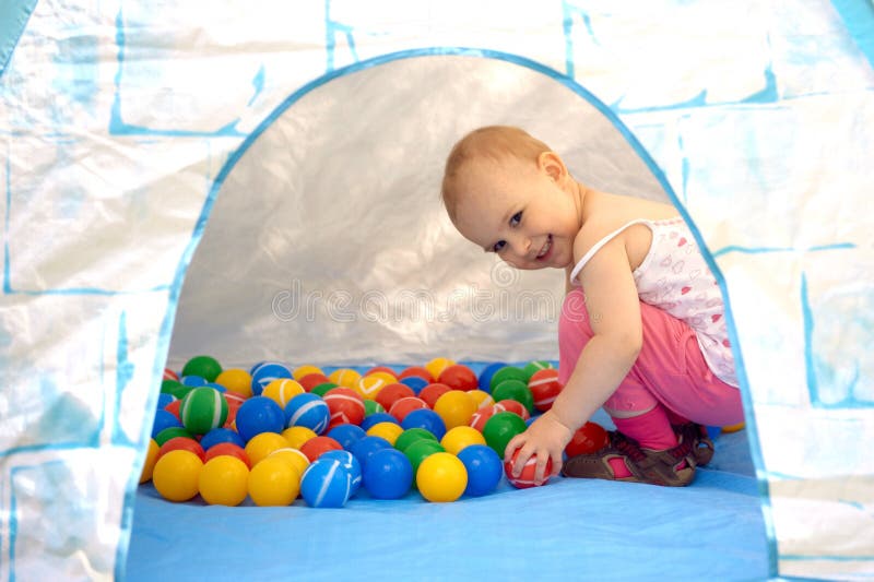 Baby playing with balls stock image. Image of sitting 32368681