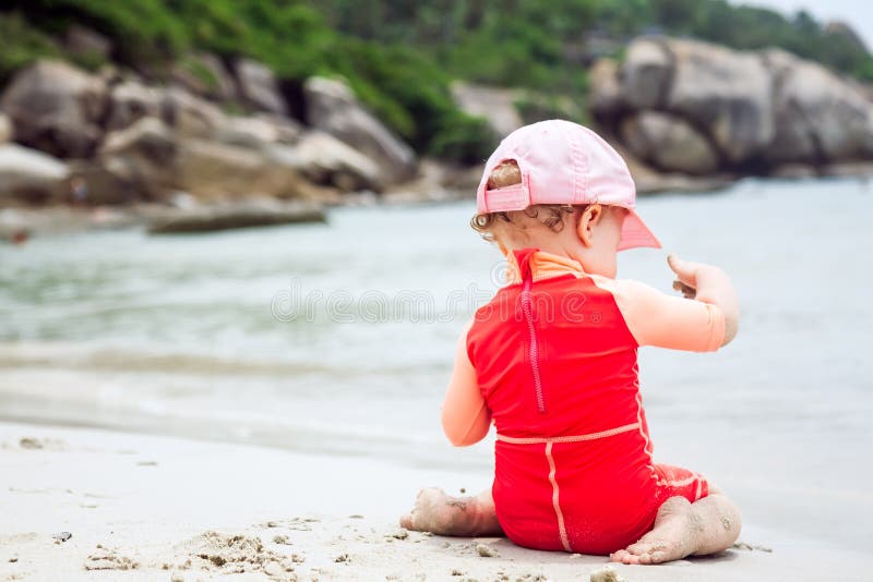Baby playing on beach with copy space during summer holidays royalty free stock photography