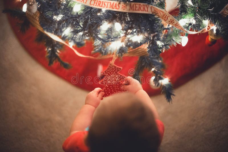 Baby Playing with a Christmas Tree Ornament Stock Photo Image of