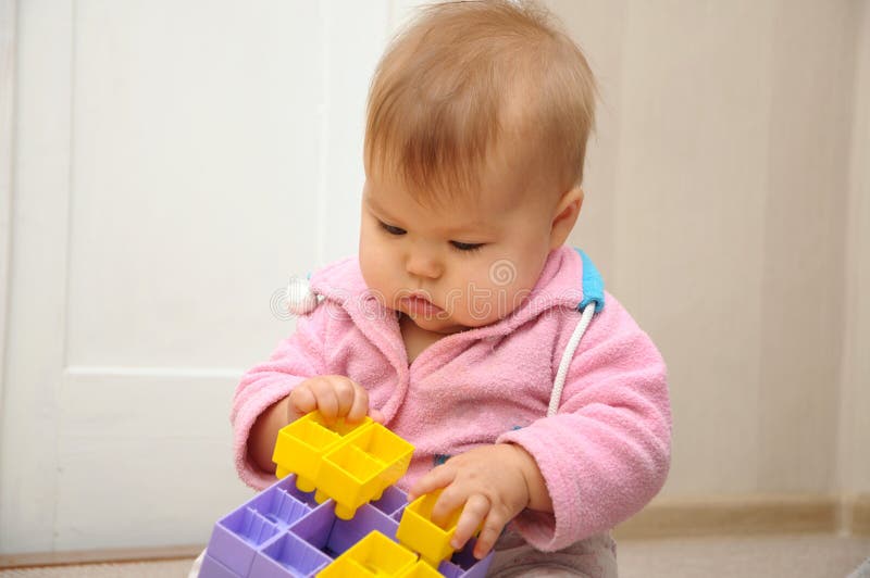 Baby playing with colored constructor stock photos Baby playing with colored constructor stock photos