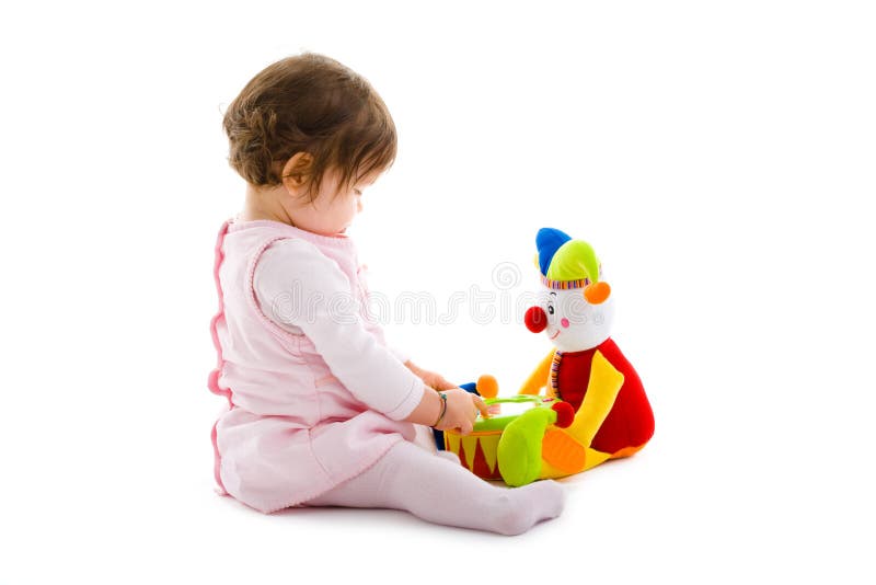 Happy baby girl sitting on floor playing with toy smiling, cotout on white background. Lovely european female stock images, royalty-free photos and pictures