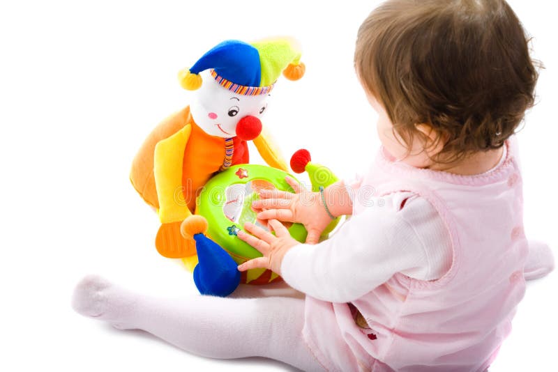 Happy baby girl sitting on floor playing with toy smiling, cotout on white background. Lovely european female stock images, royalty-free photos and pictures